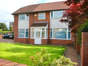 a red brick house with a white door at Pass the Keys Family Home With Parking Next To Heaton Park in Manchester