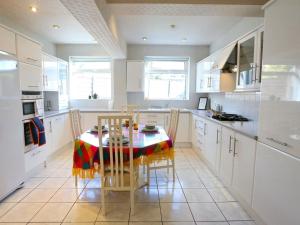 a kitchen with a table and chairs in a kitchen at Pass the Keys Family Home With Parking Next To Heaton Park in Manchester