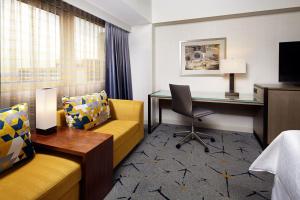 a hotel room with a desk and a bed at Sheraton Gateway Los Angeles Hotel in Los Angeles