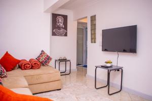 a living room with a couch and a flat screen tv at 17 Arabella Haven near Waterfront in Karen