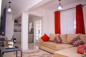 a living room with a couch and a table at 17 Arabella Haven near Waterfront in Karen