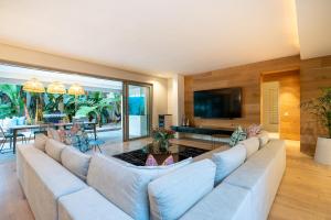 a large living room with a large couch at Amara Lincoln - 100m From Camps Bay Beach in Cape Town