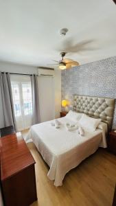 a bedroom with a large white bed in a room at Candisol Cozy Inns in Torremolinos