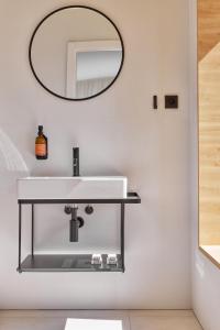 a bathroom with a white sink and a mirror at Hotel PERK in Šumperk