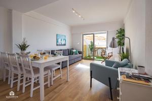 a kitchen and living room with a table and chairs at The Pateo Beach Apartment - Santa Cruz in Santa Cruz