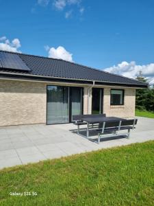 a picnic bench sitting in front of a building at Bonico in Horsens