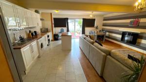 a living room with a couch and a kitchen at Elegant 2 Bedroom Chalet in Edinburgh