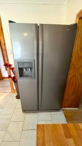 a stainless steel refrigerator in a kitchen at Elegant 2 Bedroom Chalet in Edinburgh