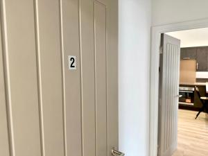 a room with a door with the number on it at Fountain Apartment No 2 with Free Parking in York