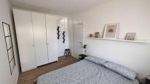 a bedroom with a bed and a white cabinet at Casa Giona in Trento