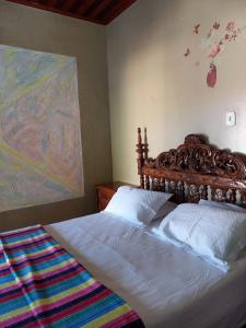 a bedroom with two beds and a painting on the wall at Hospedagem Serra da Lua in Alter do Chao