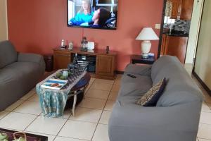 a living room with a couch and a table at J's Oasis in Nevis