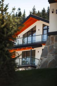 a building with balconies on the side of it at EcoBerghaus - Котеджне містечко in Bukovel