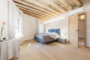 a bedroom with a bed and a table in a room at Palazzo Fritz in Badia Calavena