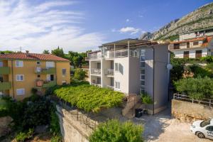 a view of a apartment building with a vineyard at Villa LANA*** in Omiš