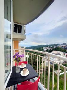 a balcony with a table and chairs with a view at Tagaytay Condo Staycation in Iruhin