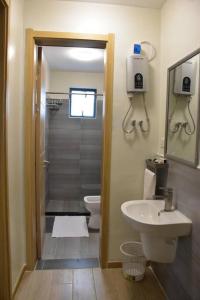 a bathroom with a shower and a toilet and a sink at Blissful Airport Serviced Apt. in Nairobi
