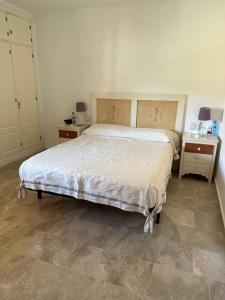 a bedroom with a large bed and two night stands at Manilva Beach: Your Costa del Sol Getaway! in Castillo de Sabinillas