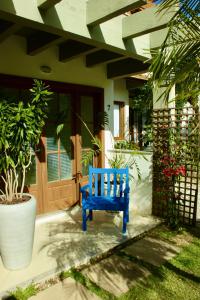 eine blaue Bank, die vor einem Haus sitzt in der Unterkunft La Menina Mole Beachfront House! 4BR/4,5Baths in Florianópolis