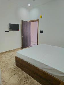 a bedroom with a large bed in a room at Motel Ilika in Bilāspur