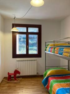 a bedroom with two bunk beds and a red horse on a wooden floor at Bonito apartamento en Ezcaray in Azarrulla