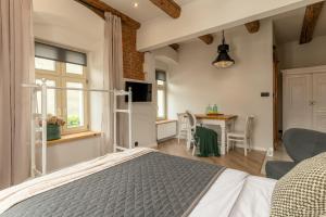 a bedroom with a bed and a table with chairs at PropertiesForYou in Bielsko-Biała