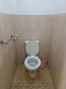 a bathroom with a toilet in a stall at Hotel Maerakatja Yogyakarta in Jetis