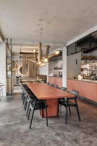 a dining room with a large wooden table and chairs at Hotel PERK in Šumperk