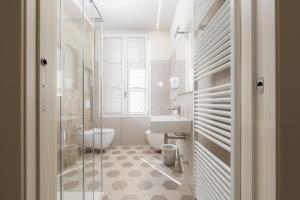 a bathroom with a shower and a toilet and a sink at Palazzo Fritz in Badia Calavena