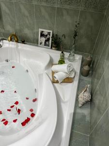 a bathroom with a white sink with red hearts on it at Villa Nogueroles in Sanchidrián +58 photos