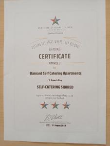 a white framed diploma with stars on it at Barnard Self-Catering Apartments in St Francis Bay