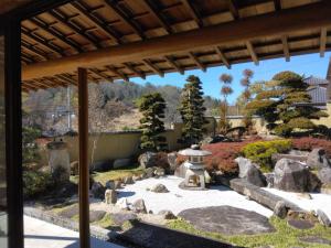 a japanese garden with a fountain and rocks at BANRYU 萬龍 バンリュウ in Iida