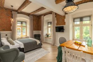 a bedroom with a bed and a dining room at PropertiesForYou in Bielsko-Biała