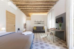 a bedroom with a bed and a desk and a couch at Palazzo Fritz in Badia Calavena
