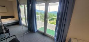 a room with sliding glass doors with a view at Cer de munte in Nucşoara