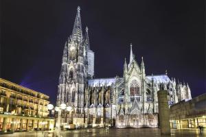 a large cathedral at night with lights on it at Apartment Cologne Center in Cologne