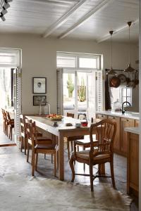 a kitchen with a large wooden table and chairs at Mukti in Nieu-Bethesda