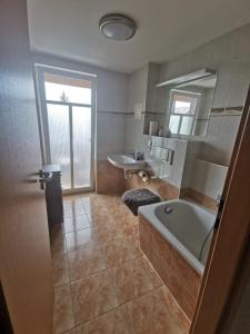 a large bathroom with a tub and a sink at Apartment Bürgerstraße, 50 q.m. in Dresden
