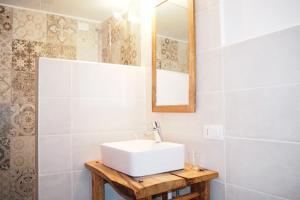a bathroom with a white sink and a mirror at Casa Cucuc in Frisanco +21 photos