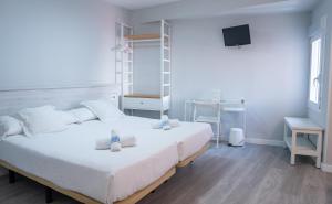 Postel nebo postele na pokoji v ubytování Hostal Viena