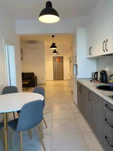 a kitchen and dining room with a table and chairs at Studios & Apartments Palas by GLAM APARTMENTS in Iaşi