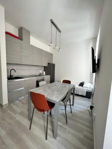 a kitchen and dining room with a table and chairs at Luxury apartment + garage in Trieste