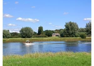 a person in a boat on a river at The nicest farmhouse in Holland! in Epse