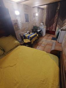 a bedroom with a yellow bed in a room at Menton.Studio in Menton