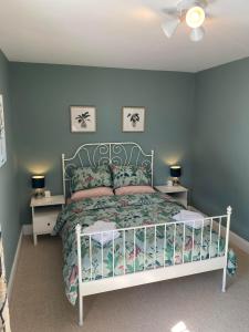 a bedroom with a bed and two night stands at Brooklands Guest House in Llandrindod Wells