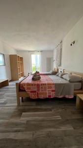 a bedroom with a large bed with a red blanket at Agritur Lavanda in Nave San Rocco