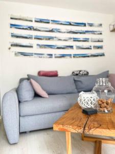 a living room with a blue couch and a wooden table at Apartment *MALA* in Žalec