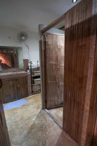 una puerta de madera abierta en una habitación con sala de música en Bangka Hostels, en El Nido