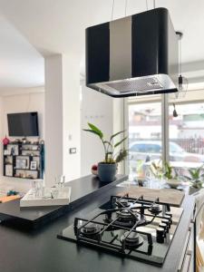 a kitchen with a black counter top with a stove at Apartment *MALA* in Žalec