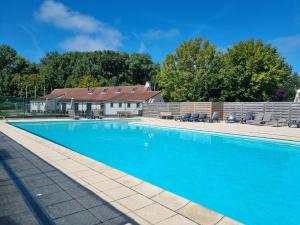 a swimming pool in front of a house at vakantiewoning 266 in De Panne